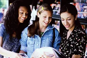 Floral Pattern Prints: Three teenage girls reading a magazine