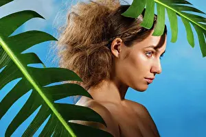 Green Color Prints: Thoughtful naked woman with palm leaves against blue sky