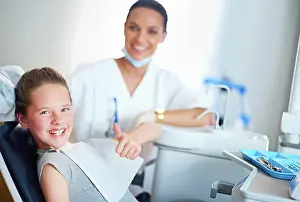 Cleaning Prints: Thumbs up, dentist and portrait of child in chair for cleaning