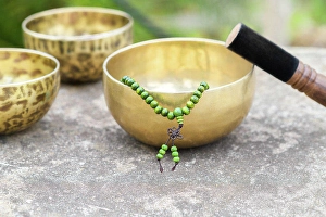 Nepal Prints: Tibetan singing bowls with sticks on the grey background outdoors