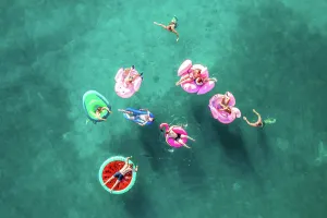 Ripple Prints: Tisno, Croatia - 9AUGUST 2019: Aerial view of people floating in the turquoise waters