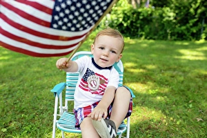 Kindness Prints: Toddler boy holding American flag wearing Patriotic shirt