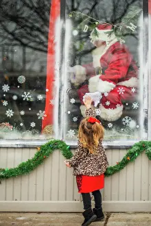 Santa Prints: Toddler reaches for santa through window