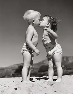 Affectionate Prints: Toddlers kissing on the beach