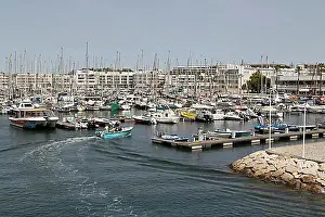 Trips Prints: Tour boat with tourists and sailing boats in the marina of Lagos