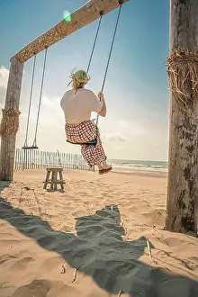 Benelux Prints: Tourist on the beach on a swing, Zandvoort, Netherlands