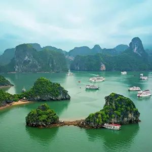 Berg Prints: Tourist junks in Ha Long Bay, Vietnam Tourist junks floating among limestone rocks at early morning in Ha Long Bay