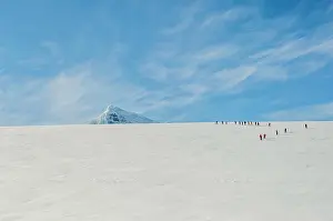 Glacier Prints: Tourists hiking on the glacier at Damoy Point