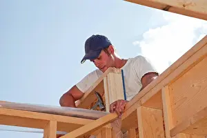Hammer Prints: tradesman working on framing for new home construction, st. albert alberta canada