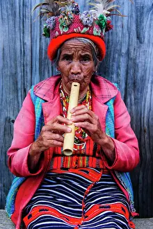 Elderly Prints: Traditional dressed Ifugao women playing the flute in Banaue