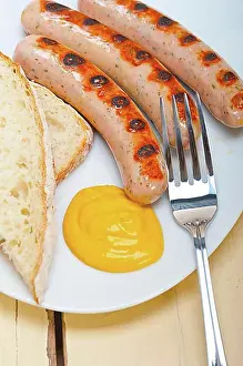 Prepare Prints: Traditional fresh German wurstel sausages grilled with yellow mustard
