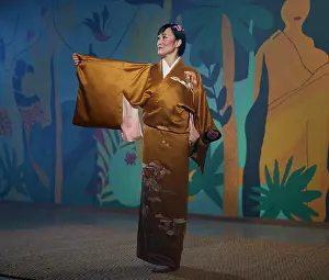 Theatrical Prints: Traditional Japanese dancer in a floral patterned kimono against an artistic backdrop