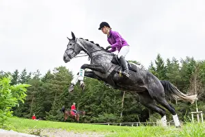 Equidae Prints: Trakehner Horse. Rider on gray mare negotiating an obstacle. Germany