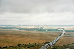 Overcast Sky Prints: A tranquil aerial view of a highway slicing through the calm countryside under an overcast sky