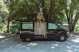 Greece Prints: traveler man sitting on the roof of the motorhome