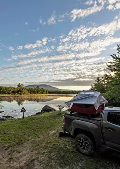 Tent Prints: Truck with tent sits next to peaceful river with mountain, Maine