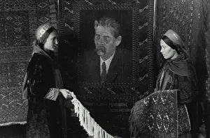 1945 Prints: Turkmenistan Soviet Socialist Republic -- Carpet-weavers of the Ashkhabad art workshop have woven a carpet with a