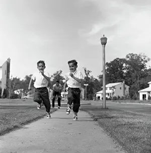 Walkway Prints: Twin boys running on pavement