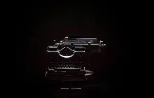 Studioshot Prints: Typewriter on table against black background