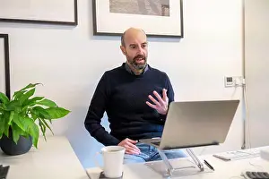 Home Office Prints: UK, Surrey, Man having virtual meeting via laptop at home
