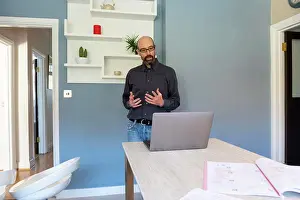 Home Office Prints: UK, Surrey, Man having virtual meeting via laptop at home
