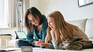 Daughter Prints: UK, Surrey, Mother helping daughter with homework