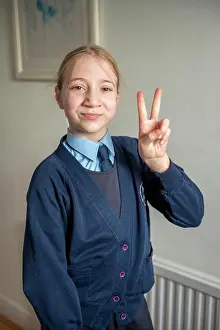 Blond Hair Prints: UK, Surrey, Portrait of smiling girl in school uniform