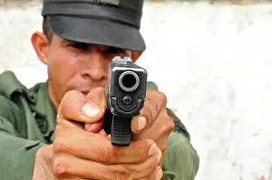Safety Prints: Uniformed police officer aiming a pistol at a tactical