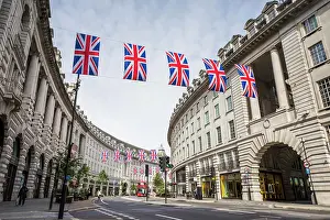 Elizabeth Ii Prints: Union Jack flags hang above Regent Street leading away from Piccadilly Circus