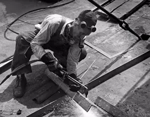 Unitedstates Prints: United States: c. 1938 A workman using an oxy acetylene torch to cut steel angle iron