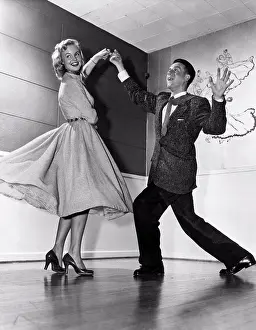 Expressive Prints: United States: c. 1958. A young couple show off some expressive moves on the dance floor