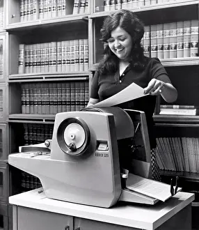 File Prints: United States: c. 1967 A woman using an A.B. Dick 525 mimeograph machine