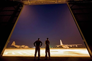 Logistics Prints: Two United States Marine aviators scan the flight line on which two KC-130J Super Hercules sit parked at Kuantan Air