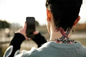Tattoo Prints: Unrecognizable girl with a tattoo taking a picture