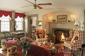 Silverware Prints: Upholstered furniture arranged around coffee table in front of fireplace with lit fire