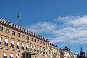 Finland Prints: Upper floors of historic buildings under a blue sky with a flag and architectural details