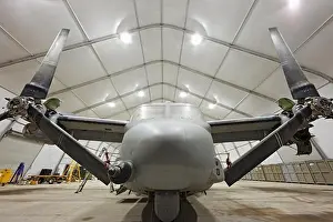 Maintenance Prints: A U.S. Marine Corps MV-22 Osprey sits in an expeditionary hangar