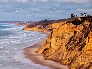 Sandstone Prints: USA, California, La Jolla. Paragliders float over Black's Beach in late afternoon