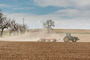 Lord Prints: USA, Colorado, Weld County. Tractor tilling a farm field