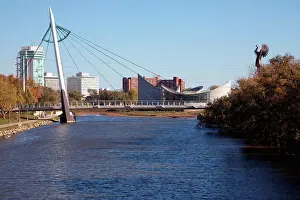 Kansas Prints: USA, Kansas, Wichita, Riverfront Pedestrian Bridge over Arkansas River with Keeper of Plains sculpture on right