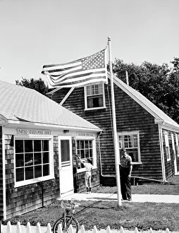 50 54 Years Prints: USA, Massachusetts, Westport, Boy dropping mail in mailbox with mature man standing behind him