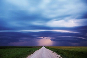 Dramatic Sky Prints: USA, Oklahoma, Dirt road disappears in distance below mesocyclone