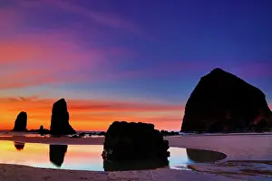 Rock Formation Prints: USA, Oregon, Cannon Beach, View of sunset afterglow over Haystack Rock