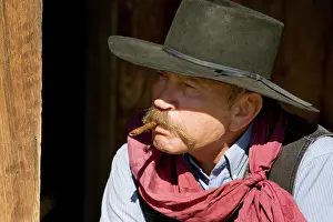 Model Release Prints: USA, Oregon, Seneca, Ponderosa Ranch. Portrait of a cowboy with cigar in mouth. (MR/PR)