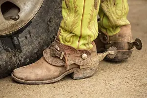 Leather Prints: USA, Texas, Cowboy boots with spurs next to pickup truck tire