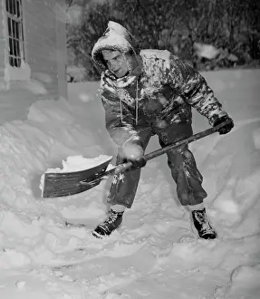 Effort Prints: USA, Vermont, Woodstock, man shoveling snow