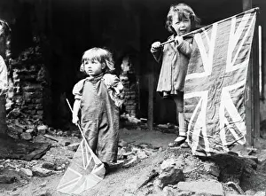 Solidarity Prints: Ve Day in London, 8 May 1945 Two small girls waving their flags in the rubble of Battersea