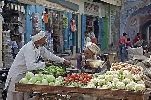 Uttar Pradesh Prints: Vendors selling vegetables on wooden cart at market in Barsana