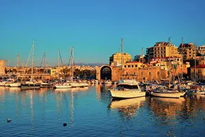 Crete Prints: Venetian Fort castle in Heraklion and moored fishing boats, Crete Island, Greece on sunset