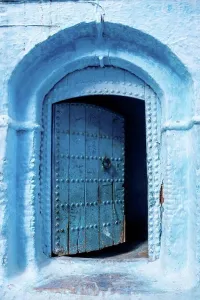 Arabian Prints: Vibrant blue colored wooden door in downtown Chefchaouen, Morocco